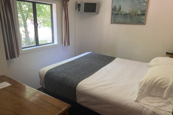 View of one of two bedrooms with a queen bed