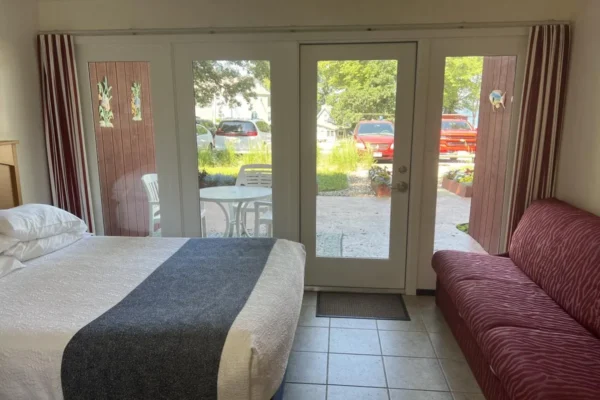 View of the main room with the queen bed, sofa sleeper, and kitchen