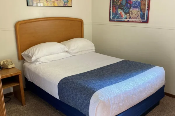 View of one of four bedrooms with a queen bed