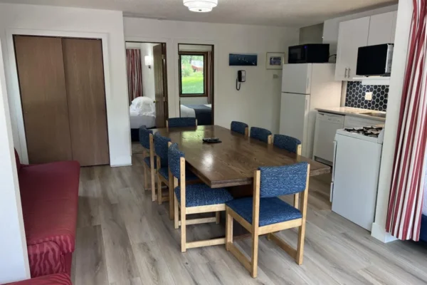 View of the dining area with the kitchen, leading to two of the bedrooms