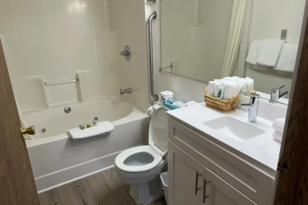 View of the first bathroom with whirlpool tub/shower