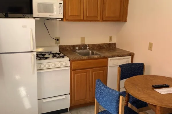 View of the full kitchen with dishwasher and dining area