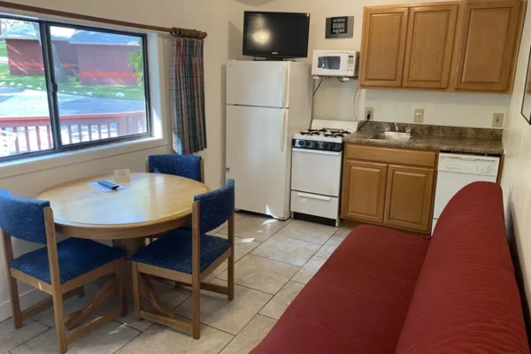 View of the living, dining, and kitchen area with a sofa sleeper