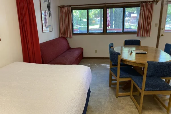 View of the main room with queen bed, sofa sleeper, and dining area